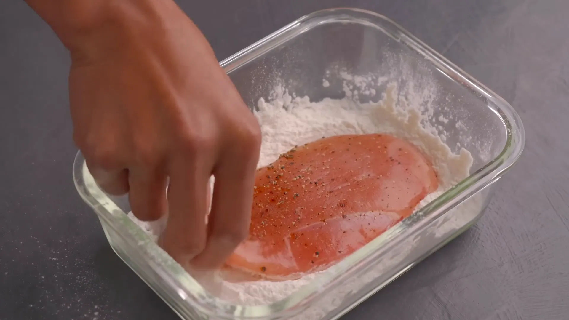 Coating chicken with flour